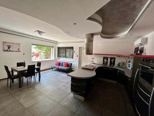 a kitchen and living room with a table and a dining room at La casa di Pepi in Gualdo Tadino