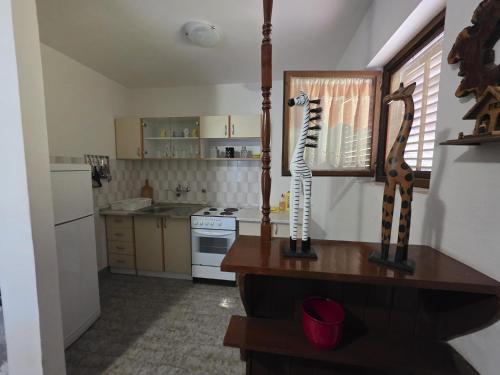 a kitchen with a table with a skeleton on it at Apartman Antica in Komiža