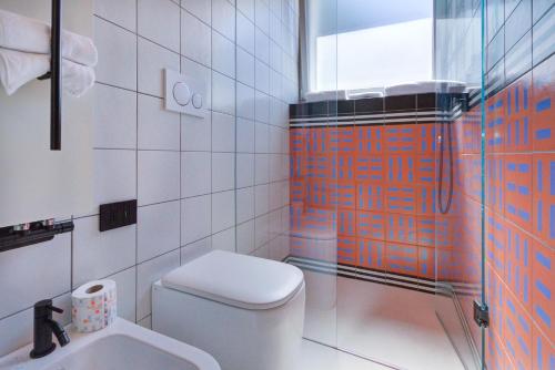 a bathroom with a toilet and a shower and a sink at Le stanze di Caterina in Cesenatico