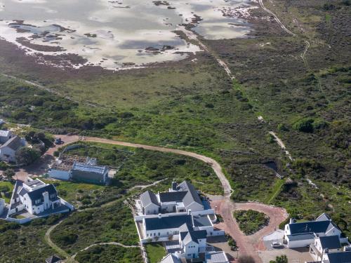 an aerial view of houses on a hill with the ocean at Kelkiewyn in Yzerfontein in Yzerfontein