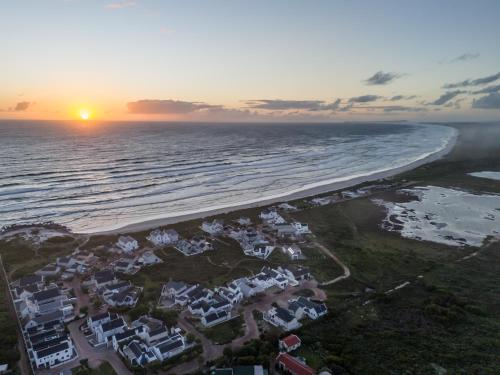 an aerial view of the beach at sunset at Kelkiewyn in Yzerfontein in Yzerfontein