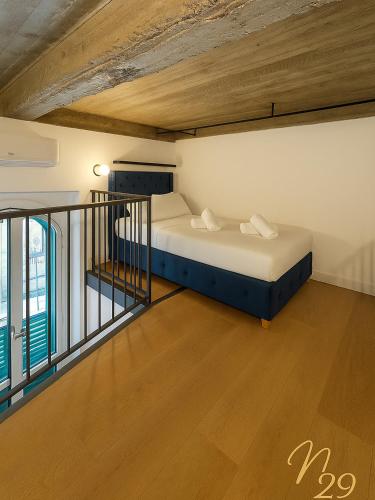 a bedroom with two beds and a balcony at Enne29 in Reggio Calabria
