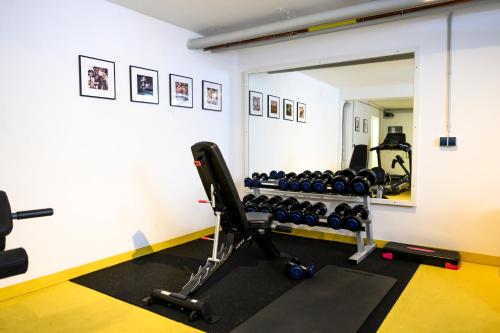 a room with a gym with a rack of dumbbells at Nikii City Hotel in Leverkusen