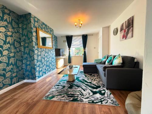 a living room with a couch and a table at Comfy 3 Bedroom House Near CovArena & TrainStation in Exhall