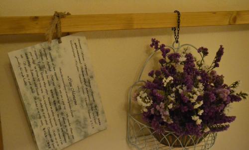 a bunch of flowers in a hanging basket next to a clipboard at Casa Mortarino in Bozzole