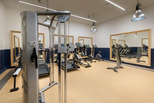 a gym with treadmills and ellipticals at Hotel Tres Reyes San Sebastián in Donostia-San Sebastián