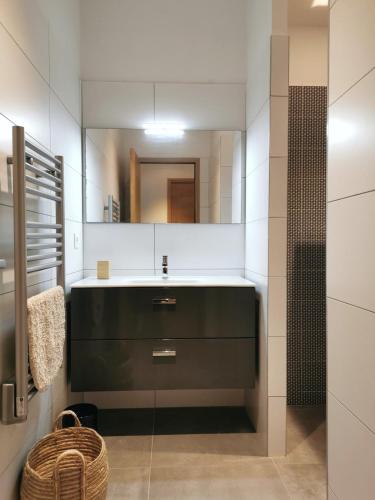 a bathroom with a sink and a mirror at Casa Lunga à Erbalunga- A deux pas de la plage in Brando