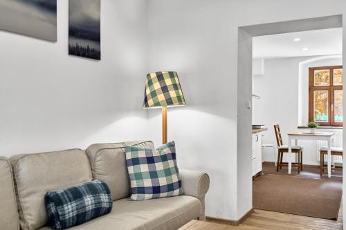 a living room with a couch and a table at Studio Jáchymov by Mountain ways in Jáchymov