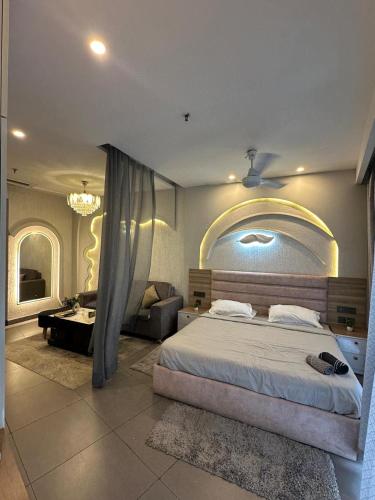 a bedroom with a large bed and a living room at Supernova sky and river view heaven in Noida