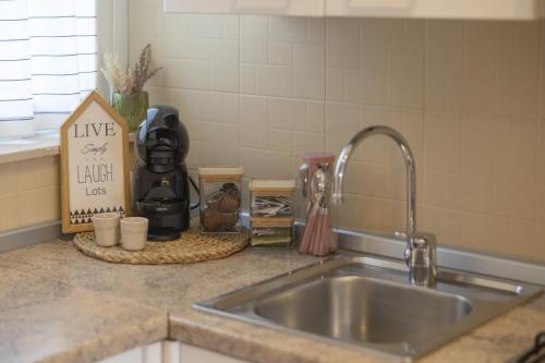 a kitchen counter top with a sink and a counter top at Conchiglia design vista mare/spiaggia+parking in Diano Marina