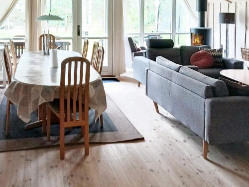 a living room with a table and a couch at 4 star holiday home in Ålbæk in Bunken