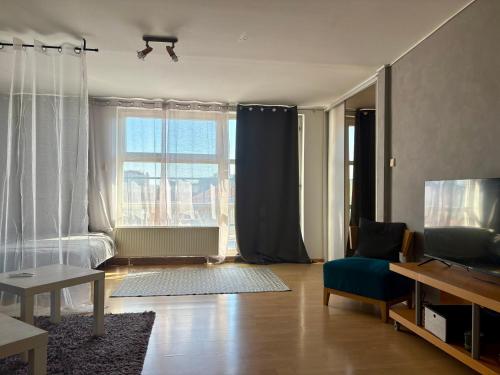 a living room with a bed and a television at Oldtown Magic Cityhub in Bratislava