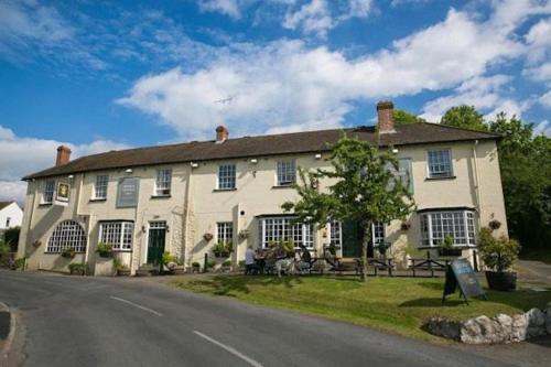 a large white house on the side of a road at The Rose & Crown, Ashbury in Ashbury