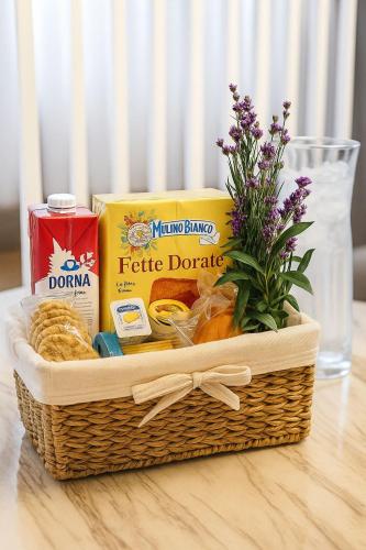 a basket filled with food and flowers on a table at YamaLuxe Luxury Apartments - București in Bucharest