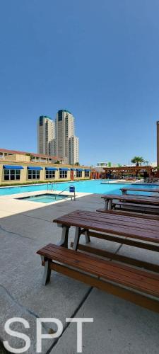two picnic tables sitting next to a swimming pool at Gulfview I #205 in South Padre Island