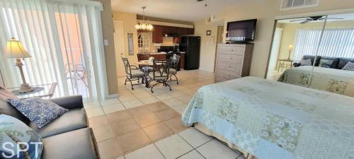 a bedroom with a bed and a living room at Gulfview I #205 in South Padre Island