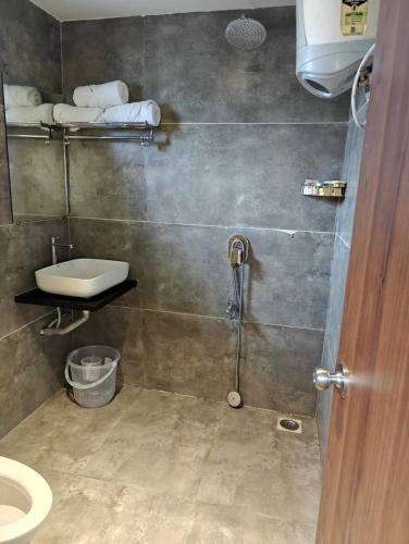 a bathroom with a shower and a sink and a toilet at Valley Vista 3BHK Pool Villa in Igatpuri