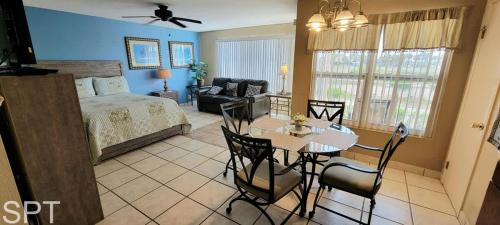 a bedroom with a bed and a table and chairs at Gulfview I #205 in South Padre Island