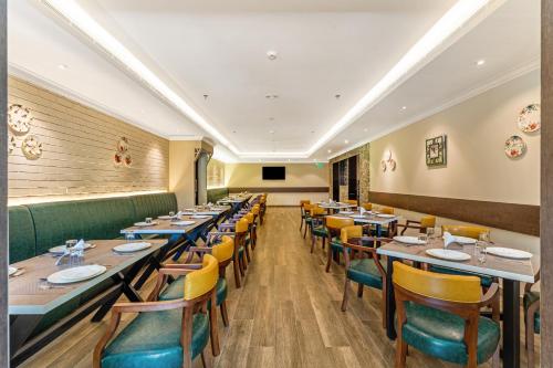a dining room with long tables and chairs at Still Waters Alaya Stays by ELIVAAS in Varkala