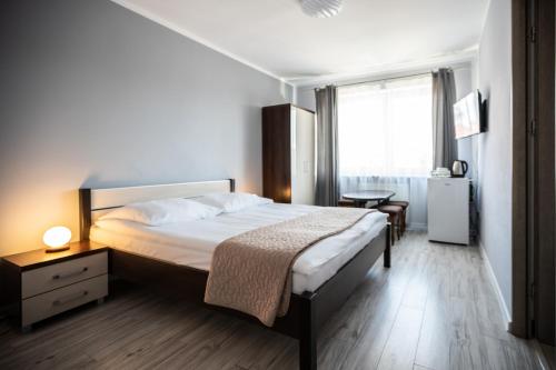 a bedroom with a large bed and a window at Pablo in Niechorze
