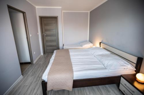 a bedroom with a large bed and a mirror at Pablo in Niechorze