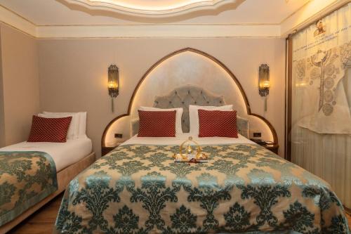 a hotel room with two beds and a large bed at Romance Istanbul Hotel Boutique Class in Istanbul
