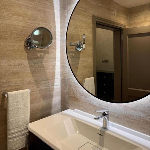 a bathroom with a sink and a mirror at Palazzo De La Sengle Boutique Hotel in Senglea