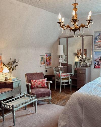 a bedroom with a bed and a chandelier at La!Maison am Rhein in Trebur