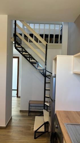 a kitchen with a spiral staircase in a house at Asterias in Skiros