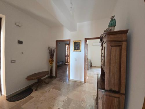 a living room with a table and a bench in it at Dal Falegname in Roccalumera