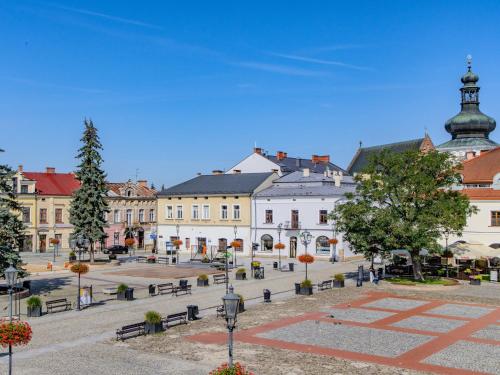 a town square with benches and a building at The Old Townhouse III in Krosno