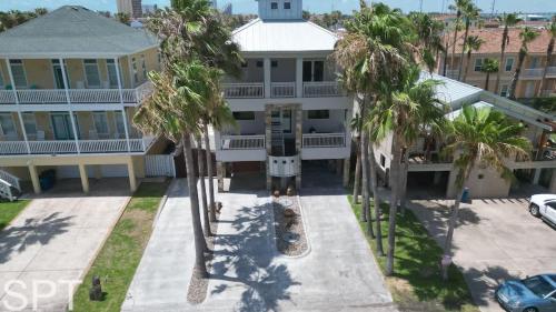an aerial view of a house with palm trees at Luxury Remodel - Sleeps 20 - Pool - Go VIP in South Padre Island