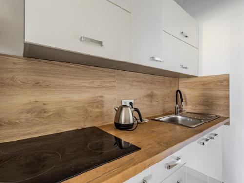 a kitchen with a tea kettle on a counter at The Old Townhouse III in Krosno