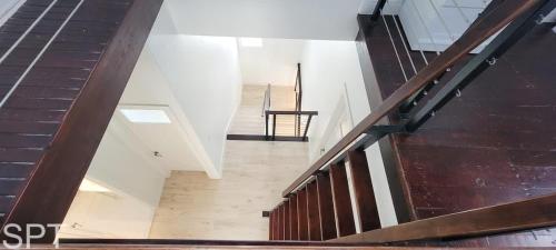a staircase in a building with wood and white walls at Luxury Remodel - Sleeps 20 - Pool - Go VIP in South Padre Island