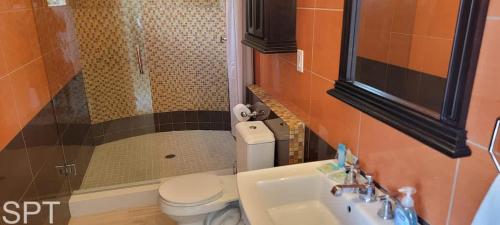 a small bathroom with a toilet and a sink at Luxury Remodel - Sleeps 20 - Pool - Go VIP in South Padre Island