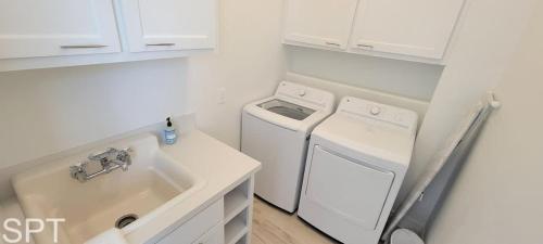 a kitchen with a washing machine and a sink at Luxury Remodel - Sleeps 20 - Pool - Go VIP in South Padre Island
