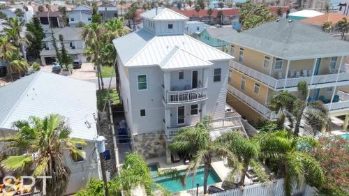 an aerial view of a house with a pool and palm trees at Luxury Remodel - Sleeps 20 - Pool - Go VIP in South Padre Island
