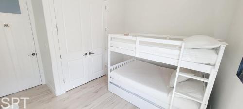 a white closet with a white shelf and white cabinets at Luxury Remodel - Sleeps 20 - Pool - Go VIP in South Padre Island