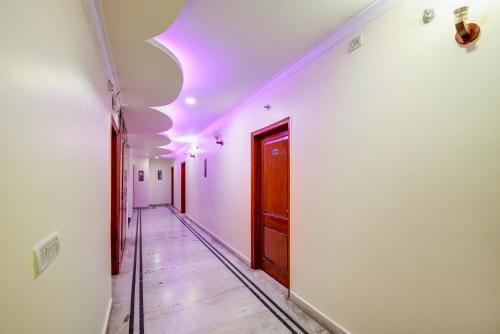 a hallway with a purple light on the ceiling at Hotel Gracious - Civil Line in Gurgaon