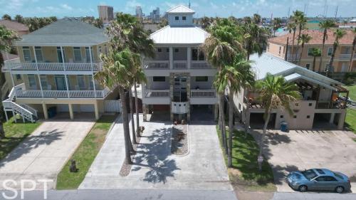 an aerial view of a large white house with palm trees at Luxury Remodel - Sleeps 20 - Pool - Go VIP in South Padre Island