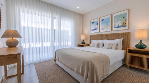 a bedroom with a large bed and a large window at Villa Aroeira with Pool by LovelyStay in Aroeira