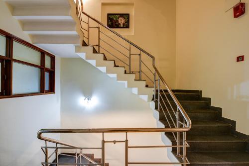 a staircase in a house with a metal railing at Hotel Gracious - Civil Line in Gurgaon