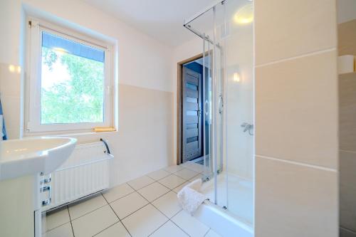 a bathroom with a sink and a shower at Pablo in Niechorze