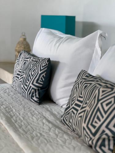 a bed with two pillows at Pousada Ilha do Vento in São Miguel do Gostoso