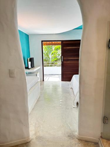 a view of a room with a hallway with a door at Pousada Ilha do Vento in São Miguel do Gostoso