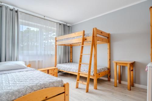 a bedroom with a bunk bed and a ladder at Pablo in Niechorze