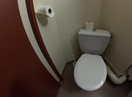 a bathroom with a toilet and a roll of toilet paper at Au Pont de la Ginéze in Barjac