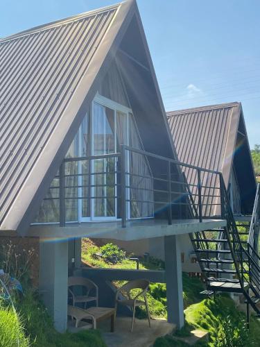 a house with a metal roof and a staircase at Twin Green in Hatton