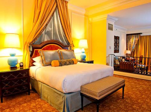 a bedroom with a king sized bed with yellow walls at Calabash Luxury Villa New Delhi IGI Airport in New Delhi