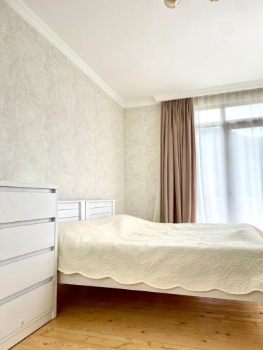 a bedroom with a bed and a window at Hillside Mestia ჰილსაიდ მესტია in Mestia